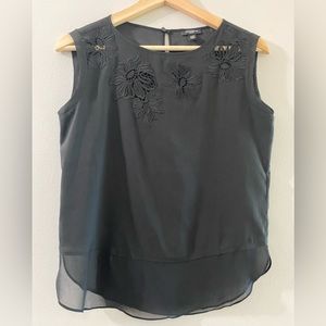 Ann Taylor black satin blouse with floral cutouts. Bottom is sheer